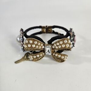 Betsey Johnson Black and Gold Bracelet with Intricate Detailing